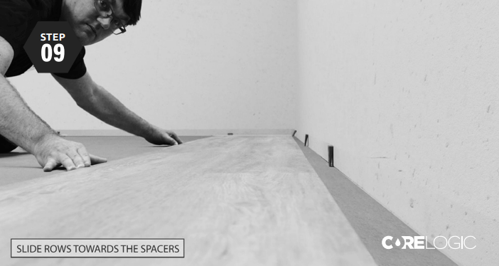 Use spacers & slide rows towards spacers Place the spacers along the walls to create an expansion space of 5mm/0,2 inches. Proceed by gently sliding rows 1 and 2 towards the spacers.